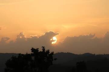 Generative AI Warm sunset painting with silhouetted trees and hills