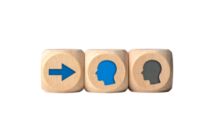 Wooden dice show a progression arrow, blue head, gray head, against black