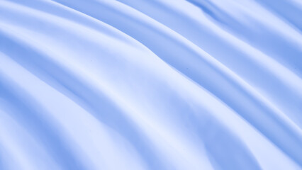 Soft, smooth light blue fabric background with elegant waves and subtle diagonal curves. Gentle folds of silk or satin texture.