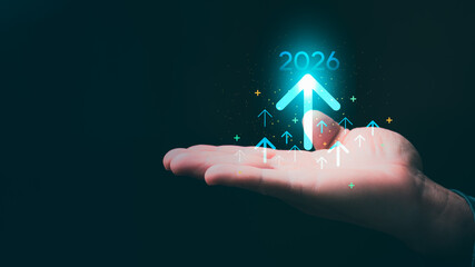 Businessman with an arrow rising to 2026 symbolizing future growth, business goals, strategic vision, and organizational development direction