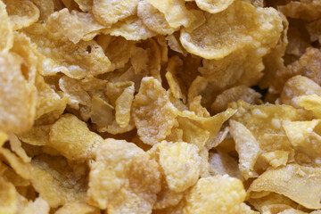 Close up macro shot of golden crispy corn flake. This satisfying and wholesome breakfast cereal delicious food for healthy morning meal full of fiber and nutrition