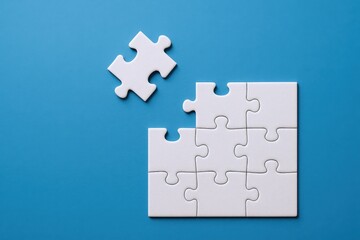 Fototapeta premium Nine Piece Jigsaw Puzzle with One Piece Detached on Blue Background, Symbolizing Problem Solving