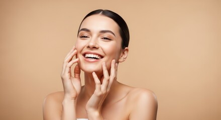 Happy young woman with glowing skin touching her face and smiling joyfully