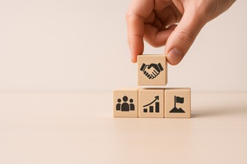 Building Blocks of Success: Hand Placing Handshake Icon, Representing Teamwork, Growth, and Achievement
