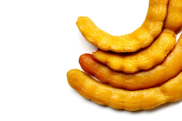 Sweet preserved tamarinds on white background.