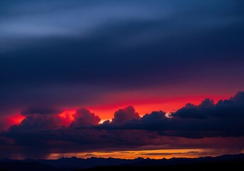 Obraz premium Intense twilight sky featuring fiery red clouds and deep indigo storm layers.