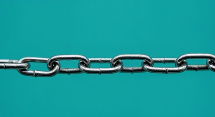 Obraz premium Interlinked: An up-close shot of a sturdy metal chain, the links gleaming against a serene background, symbolizing strength and unity.