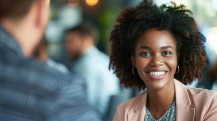 Fototapeta premium A young woman with an afro hairstyle smiling at a man in a suit.