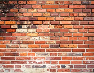 A close-up of a weathered brick wall with a textured and aged appearance