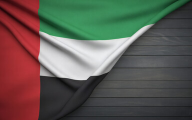 Striking United Arab Emirates flag draped on a wooden surface, a powerful symbol for patriotic themes and national celebrations