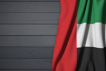 United Arab Emirates flag gracefully draped on a wooden surface, ideal for national day celebrations or UAE-themed projects