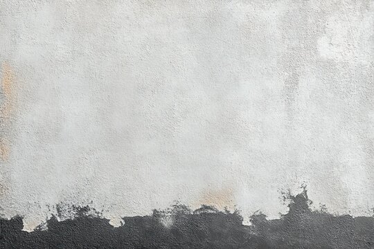 rough texture wall with peeling paint showing contrast between white and black surfaces