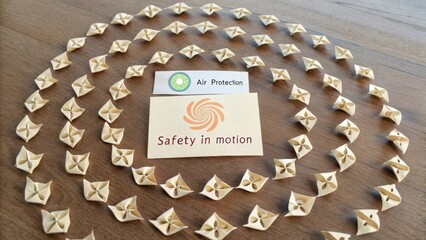 Creative arrangement of air protection symbols and safety in motion sign arranged artistically on wooden surface