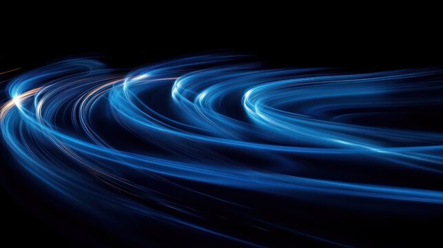 Abstract dynamic blue light trails curving gracefully over a dark background creating a sense of motion and energy