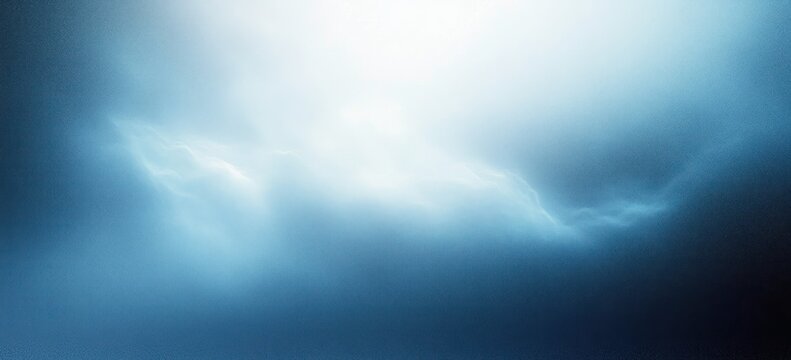 Bright glowing light surrounded by soft blue and dark misty clouds creating an ethereal and mysterious atmosphere