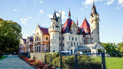 Fairy-tale Moszna Castle in Poland during autumn, historic architecture and park.