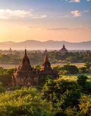 Ancient structures in a verdant valley at sunset