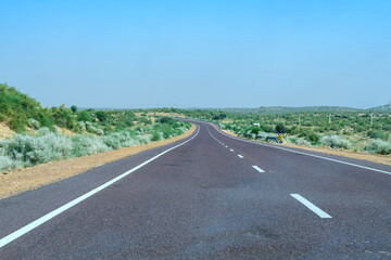 Road through the desert between Jaisalmer and Tanot, near Jaisalmer India.
