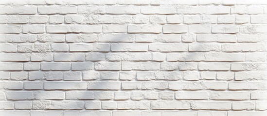 Obraz premium Close-up view of a textured white brick wall with subtle shadow patterns and uneven surface