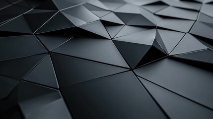 Close-up of matte and glossy black geometric triangular tiles arranged in a seamless abstract pattern with sharp edges and subtle light reflections