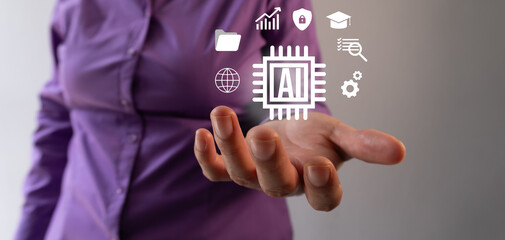 Feeding artificial intelligence. A businesswoman holds up icons about artificial intelligence.