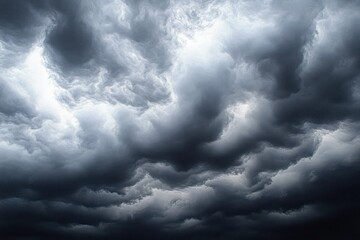 Fototapeta premium Dramatic dark storm clouds swirling in the sky creating a moody and intense atmosphere