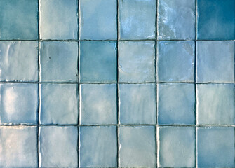 Close up of blue tiles, or blue porcelain mosaic tiles. Suitable for pool flooring or wall decoration, bathroom and kitchen tiles. Seamless background texture.