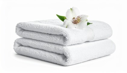 Two folded white towels stacked, adorned with a white flower and green leaves, presented on a white background.