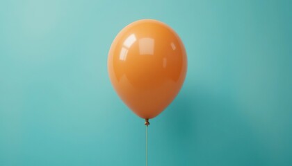 Single orange balloon floating in soft sunlight against a turquoise wall, creating a calm and modern minimalist composition
