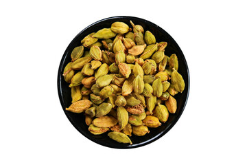 Cardamom in a black bowl isolated on a transparent background with a clipping path