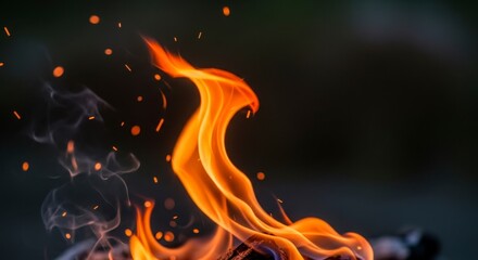 Dynamic orange fire flames with sparks dark background.