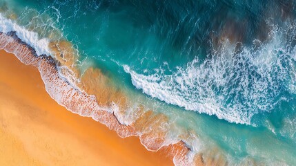 Aerial view of waves crashing on a golden sandy beach, turquoise water colors