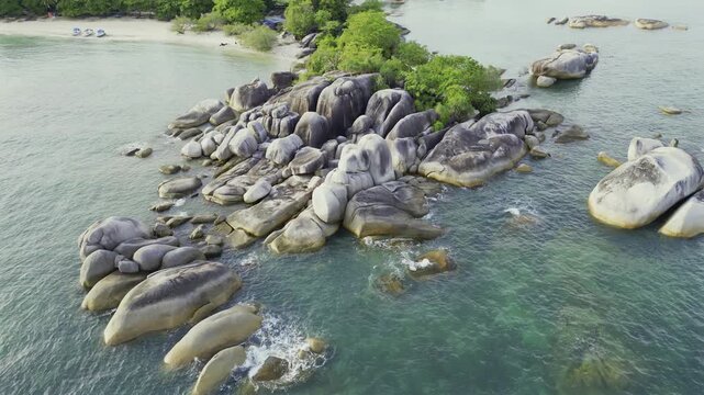 Giant smooth rocks stand strong against Belitung clear ocean water