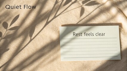 Minimalist scene featuring handwritten note and soft fabric backdrop with delicate shadows creating a calming atmosphere