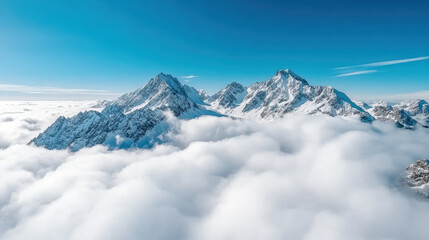 Obraz premium Majestic mountains rise above soft clouds, creating serene and tranquil landscape