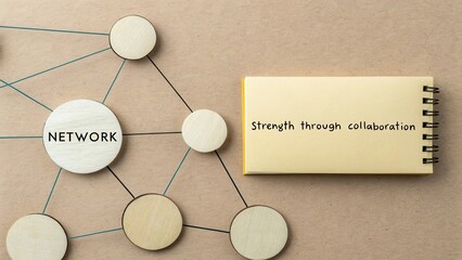Wooden circles symbolize networking concept with note emphasizing strength through collaboration on brown background