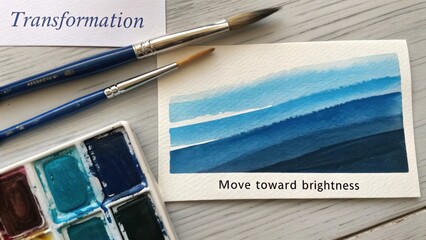 Watercolor Palette and Brushes Representing Artistic Transformation Towards Brightness and Creative Growth