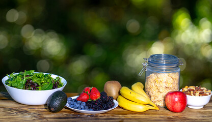 Healthy organic breakfast served on wooden table. Morning breakfast with yogurt, fruit, and...