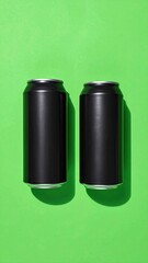 Two black cans stand on a bright green background