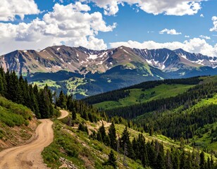 Mountain road winds through green hills under a cloudy sky
