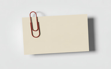 A beige note card with a red paperclip attached