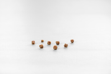 brown gallbladder lumps or pile gallstones ball lined up group and many kidney stones from cholesterol or bad food on white table for medical science background isolated with copy space