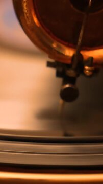 Retro vinyl gramophone from the 1920s with a brass horn and manual spring drive mechanism, producing warm analog sound without electricity, symbolizing antique music elegance and charm