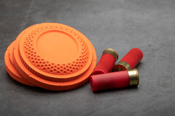 Clay shooting target and shotgun bullets on texture background ,Clay Pigeon target game © Suttiwan
