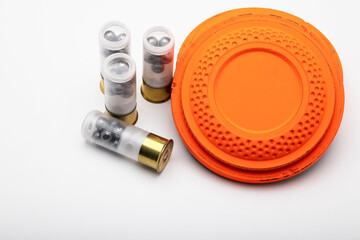 Clay shooting target and shotgun bullets on white background ,Clay Pigeon target game