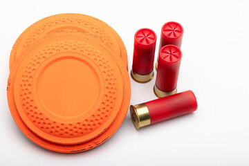 Clay shooting target and shotgun bullets on white background ,Clay Pigeon target game © Suttiwan