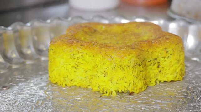 Bright saffron grains uncovered, Rustic tray displays vibrant saffron rice with crust, Hands lift decorated saffron rice to showcase golden crust and vibrant grains