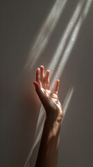 Soft, graceful female hand reaches toward warm sunlight, symbolizing hope, serenity, connection with nature, and gentle elegance in a luminous, peaceful setting.
