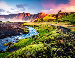Scenic landscape with mountains, stream, and vibrant mossy terrain