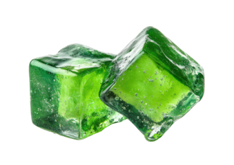 Two vibrant green, translucent ice cubes on black